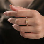 14k yellow gold signet wedding ring featuring a rectangular grid of micro pave-set diamonds, worn on a woman's ring finger.