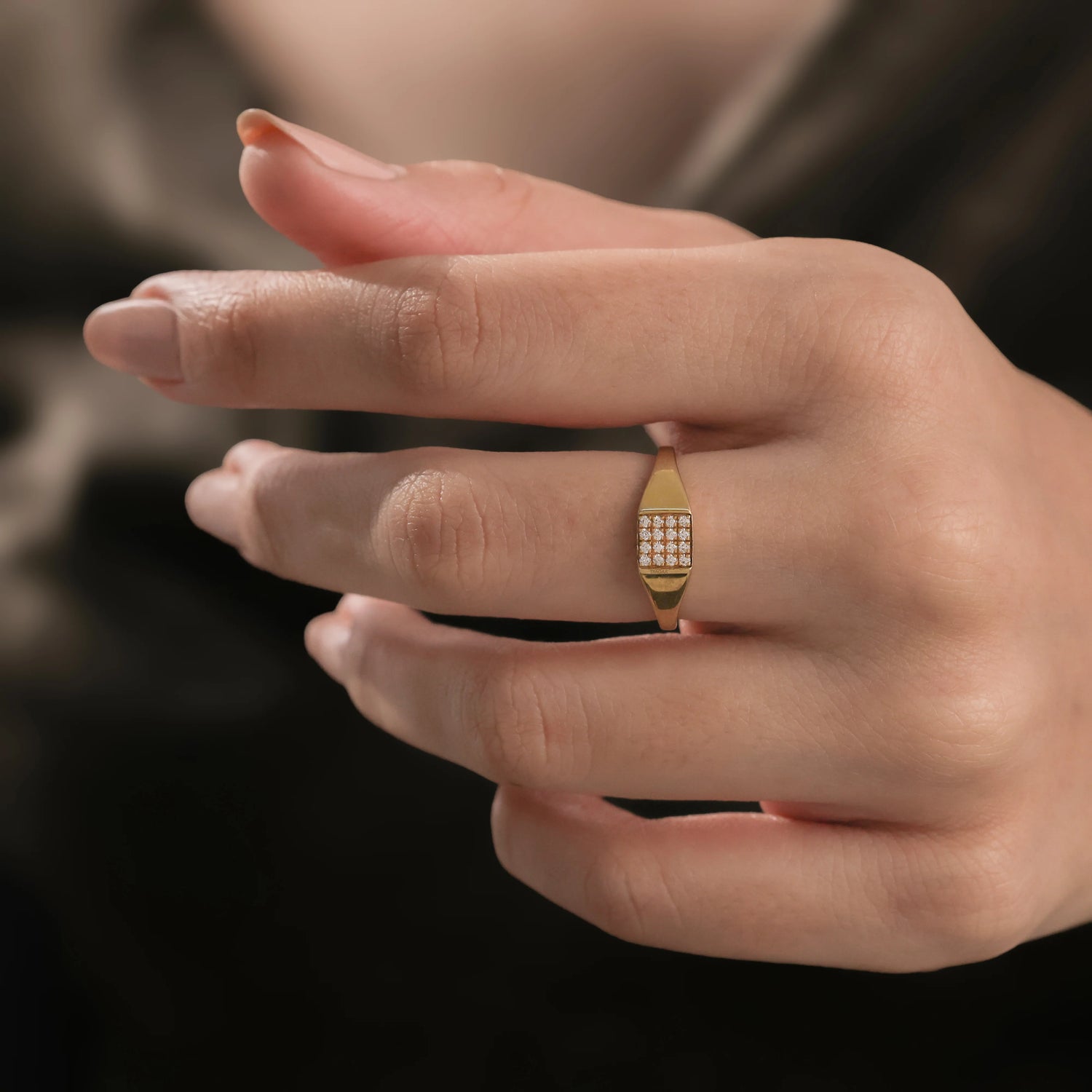 14k yellow gold signet wedding ring featuring a rectangular grid of micro pave-set diamonds, worn on a woman's ring finger.