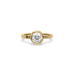 This yellow gold ring displayed on front view is made with brilliant round solitaire diamond set in bezel setting