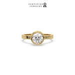 This yellow gold ring displayed on front view is made with brilliant round solitaire diamond set in bezel setting