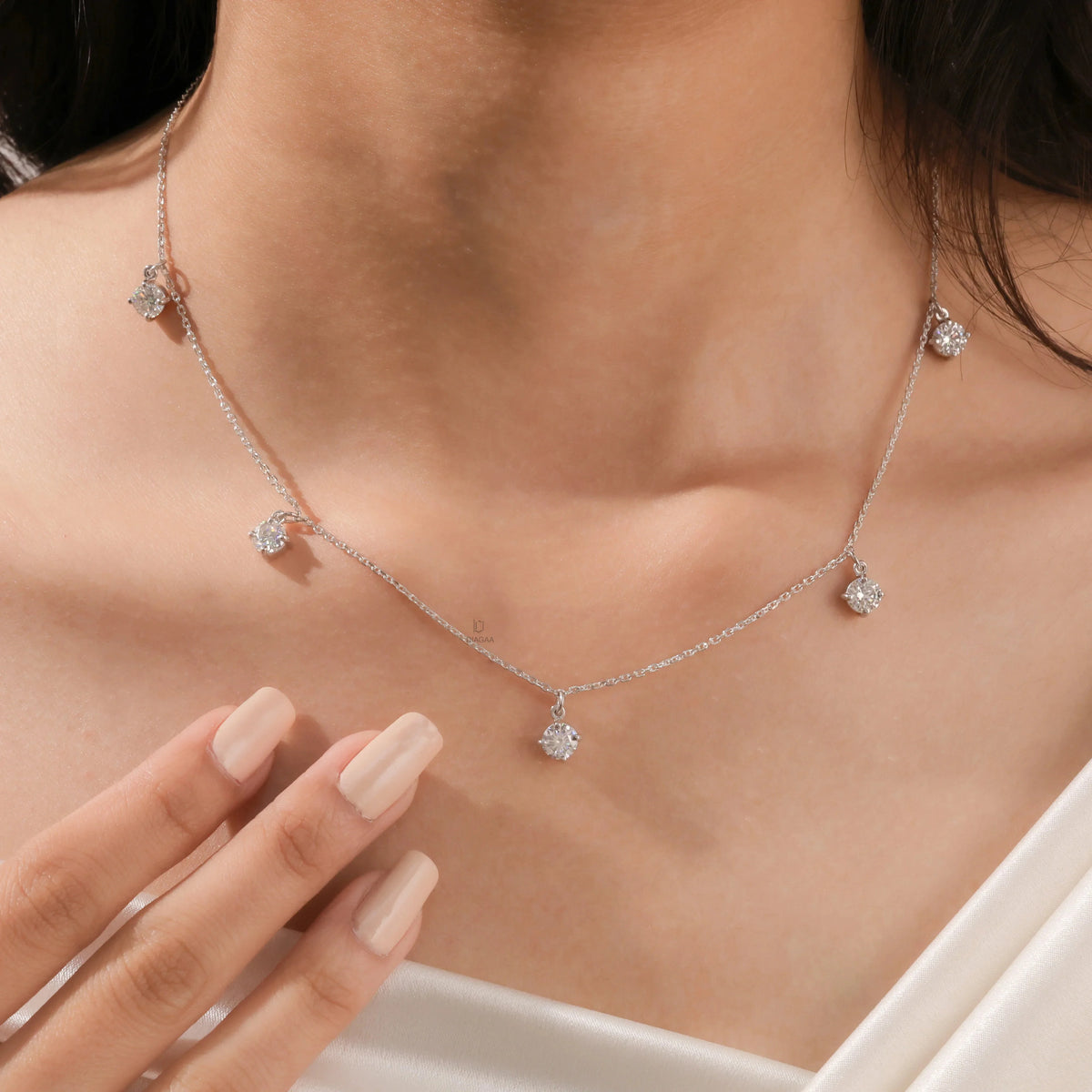 Model wearing a yellow gold Round diamond Dangling necklace featuring five prong-set round diamonds suspended along a delicate chain.