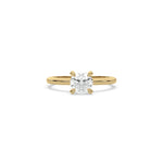A minimalist yellow gold engagement ring with a sparkling round diamond center stone on a slim, polished metal plain band.