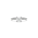 A minimalist white  gold engagement ring with a sparkling round diamond center stone on a slim, polished metal plain band.