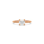 A minimalist rose gold engagement ring with a sparkling round diamond center stone on a slim, polished metal plain band.