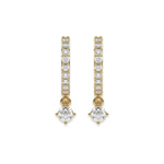 Solitaire round diamond dangling hoop earring set featuring a brilliant drop stone held in a yellow gold prong setting white background.