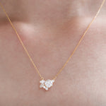 Gold necklace with a diamond pendant on a person's neck