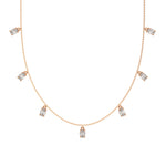 Oval Dangling Diamond Necklace made with seven oval cut diamonds each set in a prong setting, distributed evenly along the chain