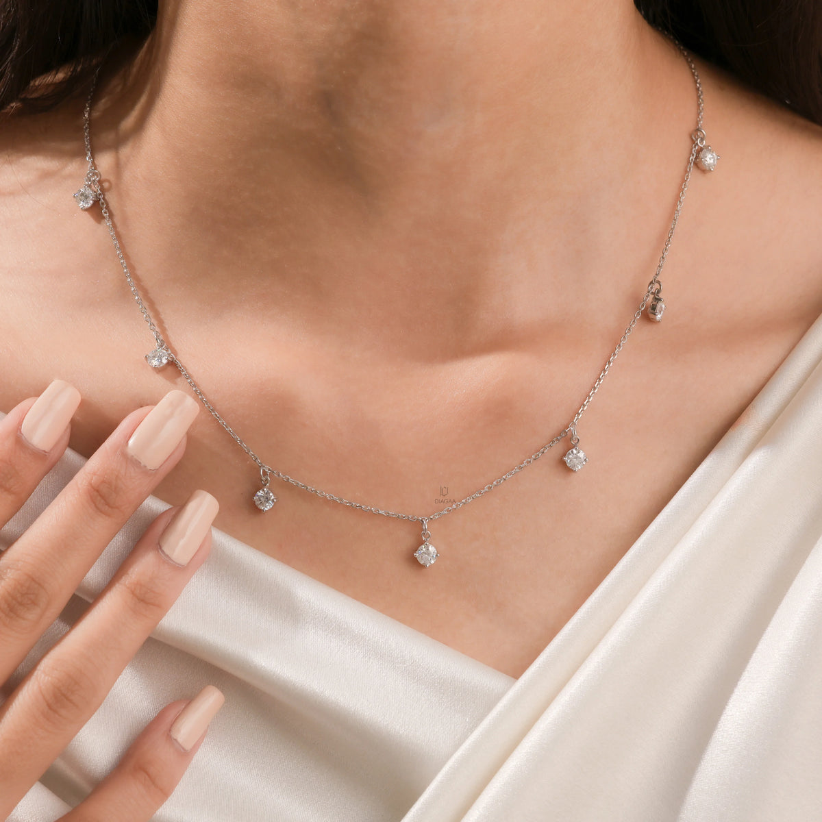 Model wearing a yellow gold Round diamond Dangling necklace featuring seven prong-set round diamond charms along a delicate chain.
