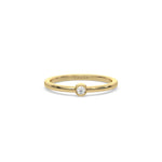 This yellow gold ring displayed on front view is made with brilliant round diamond set in bezel setting