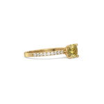 This yellow gold ring displayed in side view is made with a cushion solitaire diamond set in four-prong setting