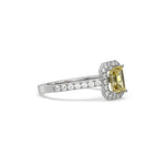 This white gold ring displayed in side view is made with a Emerald solitaire diamond set in four-prong setting