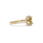 This yellow gold ring displayed in side view is made with a radiant solitaire diamond set in four-prong setting