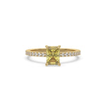 This yellow gold ring displayed in front view is made with a radiant solitaire diamond set in four-prong setting