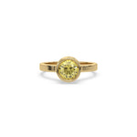 This yellow gold ring displayed on front view is made with brilliant round solitaire diamond set in bezel setting