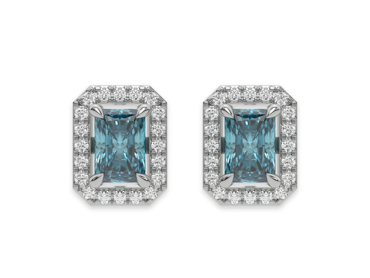 14k white gold Radiant Diamond Halo Earrings made with a fancy blue radiant cut solitaire diamond set in a four prong setting.