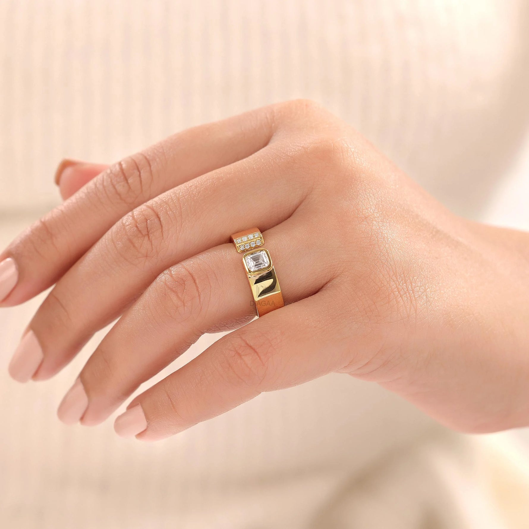 Woman wearing a yellow gold open ring with emerald and round diamonds cuff band