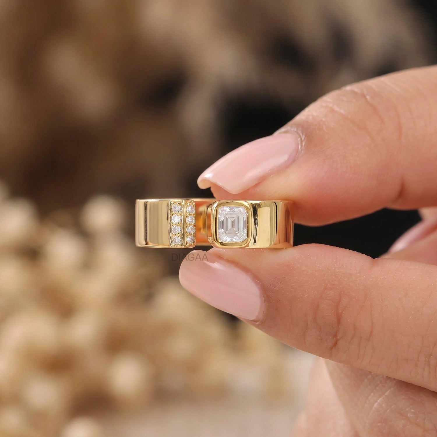 Yellow gold open ring with emerald and round diamonds in a thick band cuff wedding band