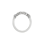 This white gold ring displayed on through finger view is made with round brilliant-cut diamonds and baguette set in a prong setting