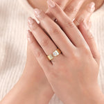 Woman wearing a 14K yellow gold open ring with Oval and round diamonds cuff band