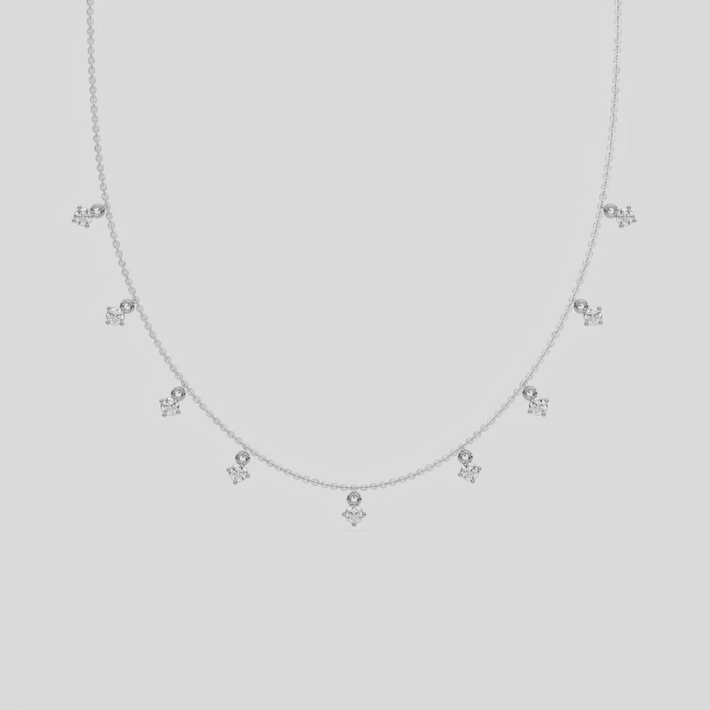 This yellow gold Round Dangling Diamond Necklace made with nine round brilliant-cut diamond set in a prong setting, distributed evenly along the chain