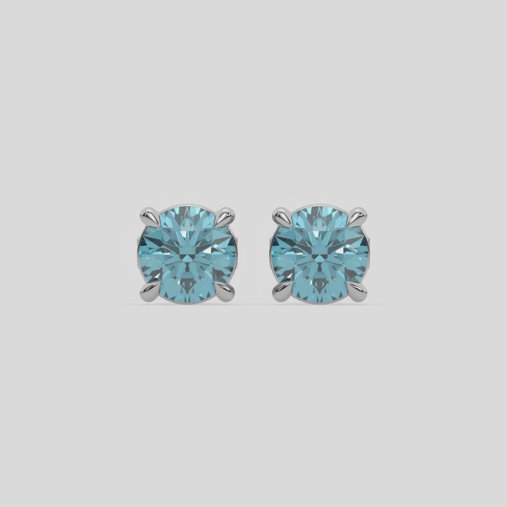 This video features a white gold Classic Round Diamond Studs made with fancy blue round brilliant-cut diamonds set in a four prong setting