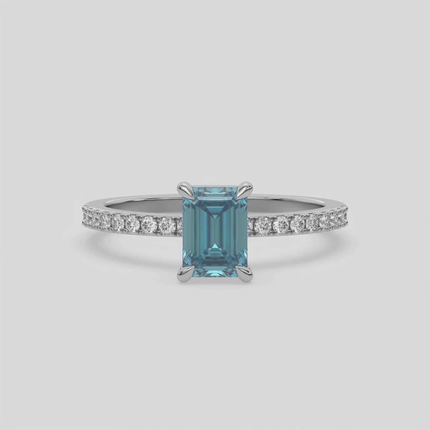 This white  gold ring displayed in front view is made with a emerald solitaire diamond set in four-prong setting