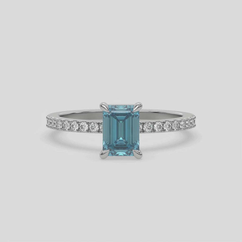 This white  gold ring displayed in front view is made with a emerald solitaire diamond set in four-prong setting