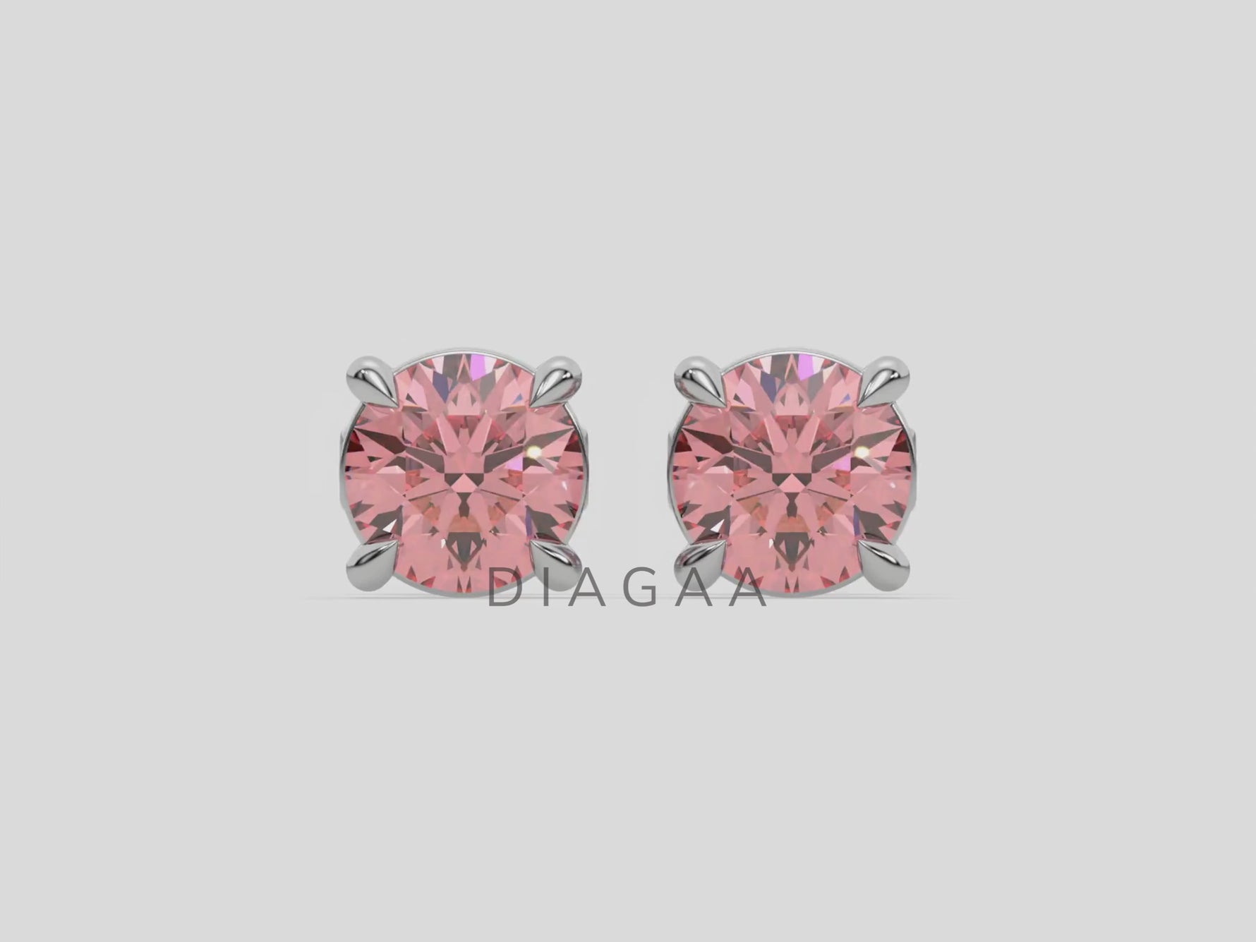 18k white gold Round Diamond Studs made with fancy pink round brilliant-cut diamonds set in a four prong setting