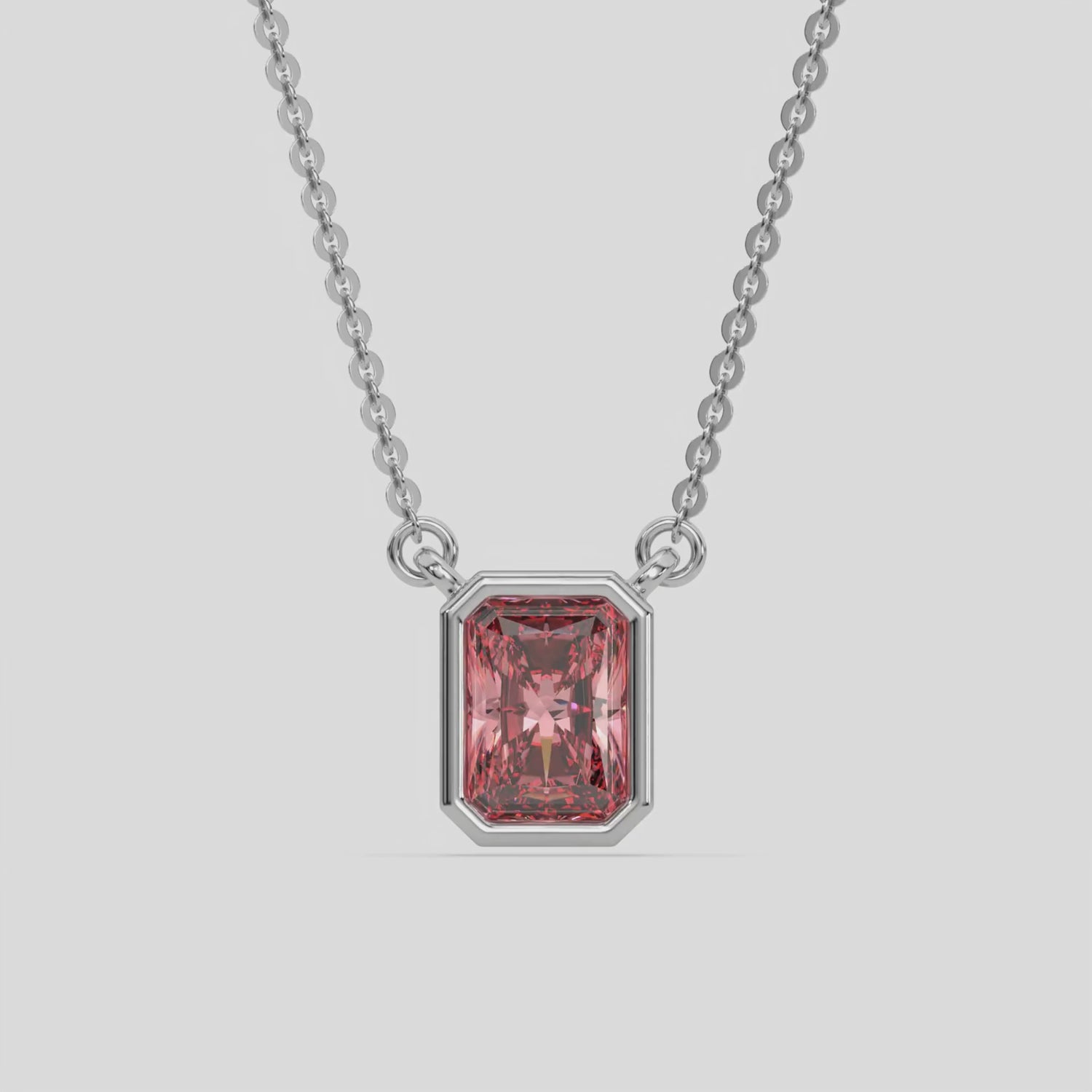 This white gold Fancy Pink Radiant Solitaire Diamond Necklace made with a fancy Pink radiant cut diamond in bezel setting with adjustable chain