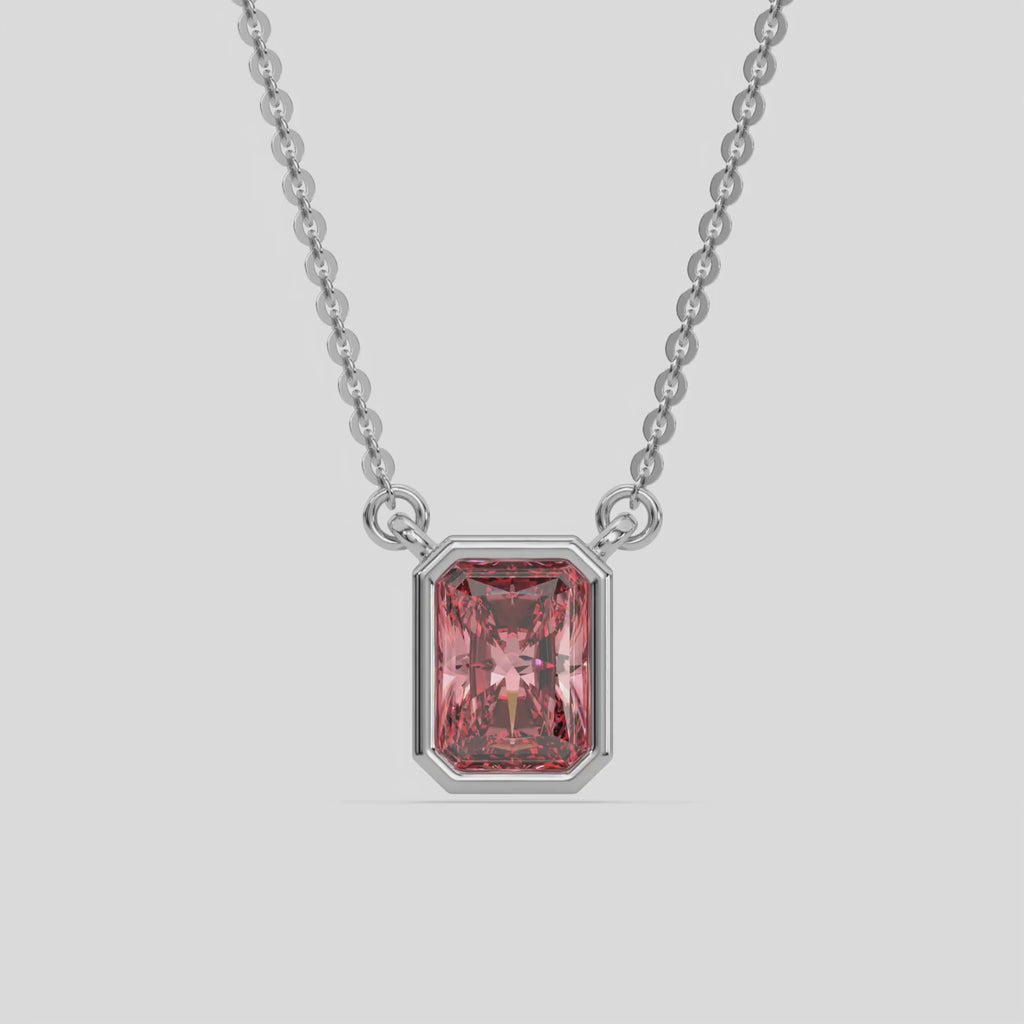 This white gold Fancy Pink Radiant Solitaire Diamond Necklace made with a fancy Pink radiant cut diamond in bezel setting with adjustable chain