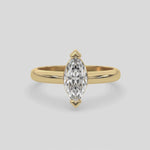 This video features a yellow gold ring features a marquise solitaire diamond elegantly secured in a two v-prong setting on a solid gold band 