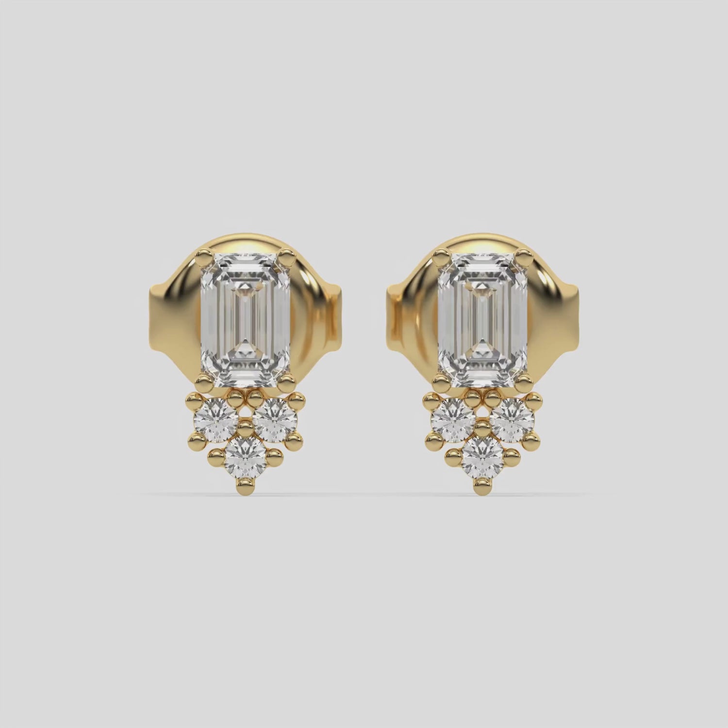 This video features a yellow gold Cluster Diamond Studs made with two different cuts of diamonds, emerald and round. The unique combination of different shapes forms a unique cluster design and all set in a prong setting