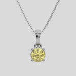 Fancy Yellow Round Solitaire Diamond Necklace made with fancy yellow round brilliant-cut diamond in a four prong setting with adjustable chain