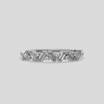 This video features a white gold A half eternity ring made with slanted baguette diamonds and round diamonds in an alternating pattern set in a shared prong setting