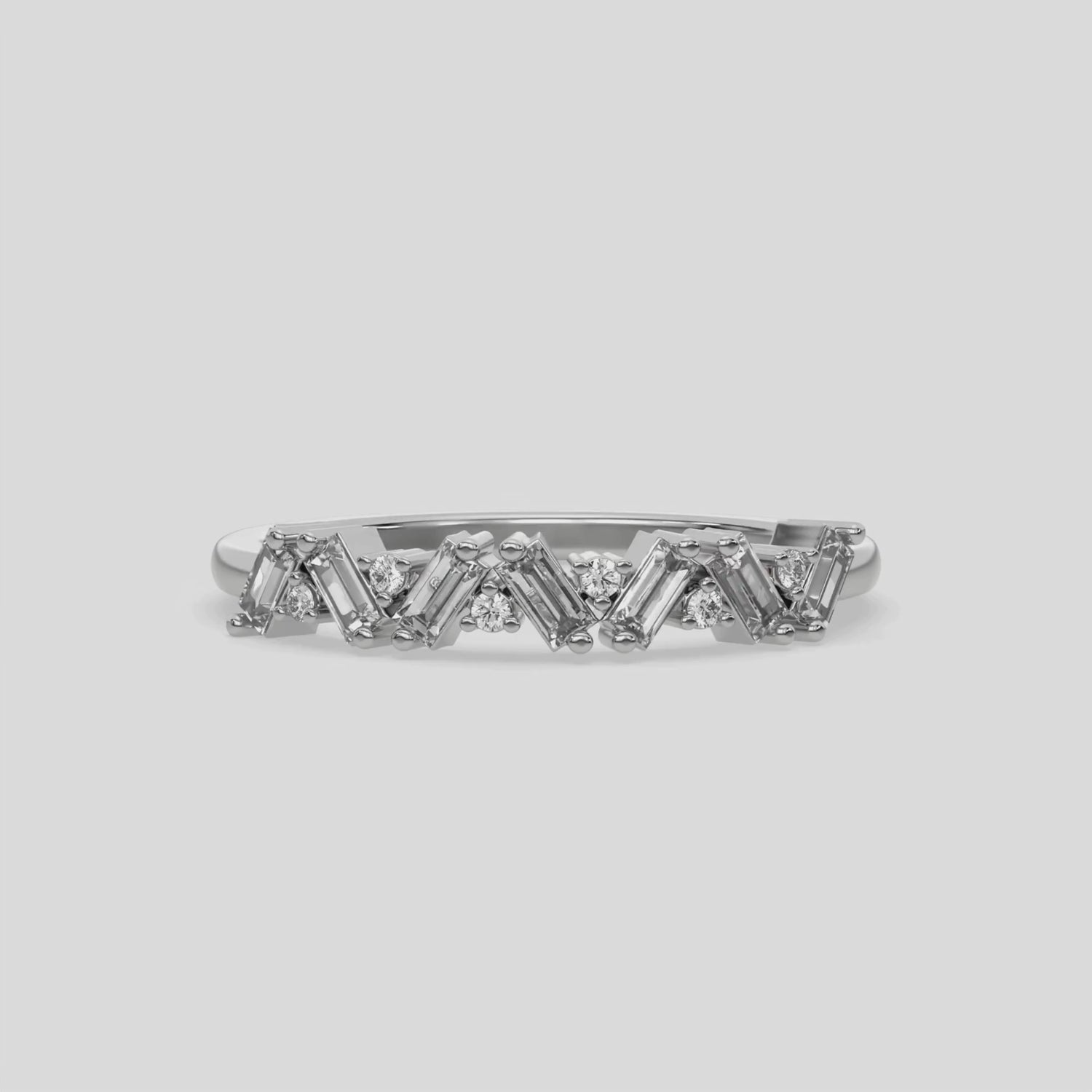 This video features a white gold A half eternity ring made with slanted baguette diamonds and round diamonds in an alternating pattern set in a shared prong setting