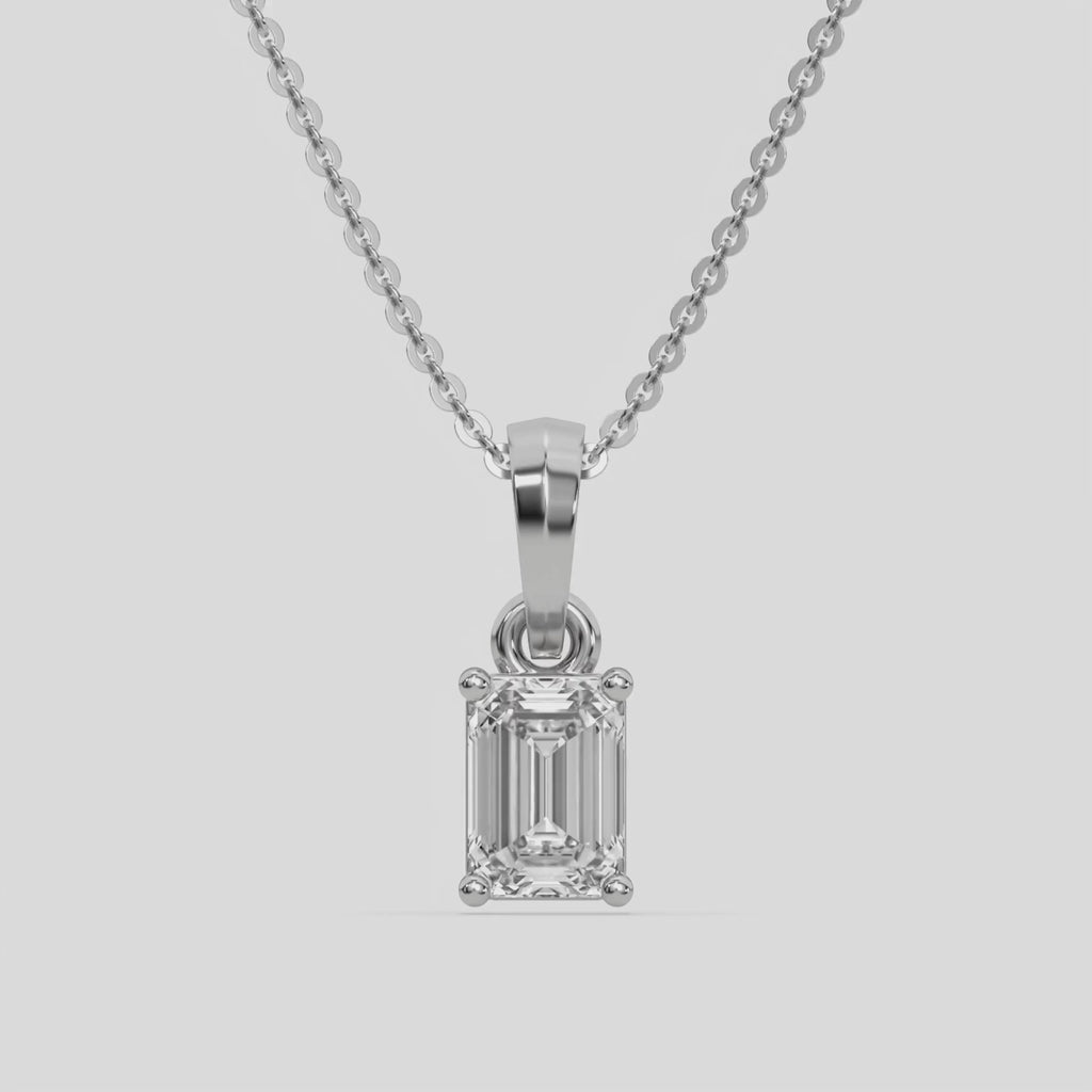  Emerald Solitaire Diamond Necklace made with an emerald cut diamond in a four prong setting with adjustable chain 