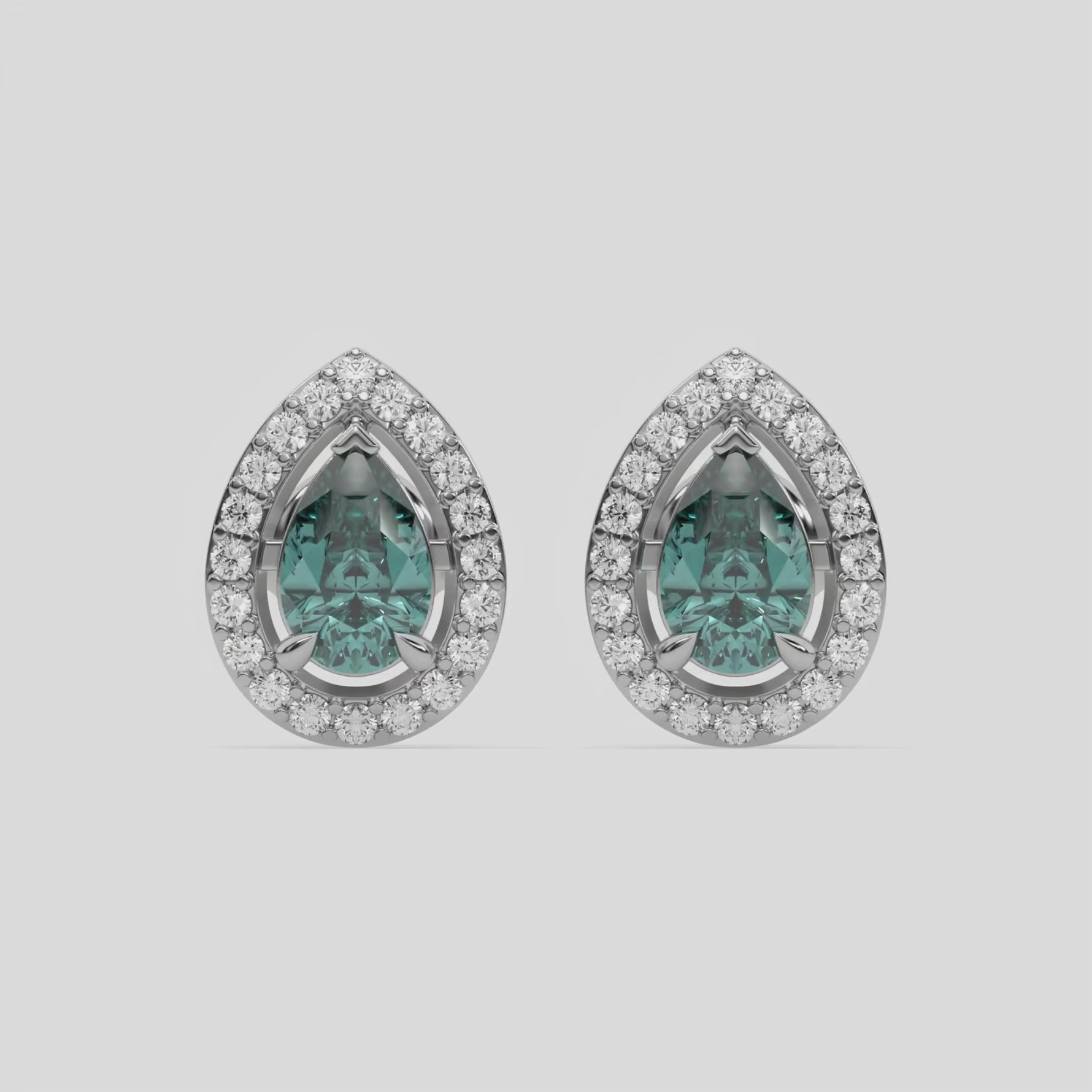 14k white gold Pear Diamond Halo Earrings made with a fancy green pear cut solitaire diamonds set in a four prong setting