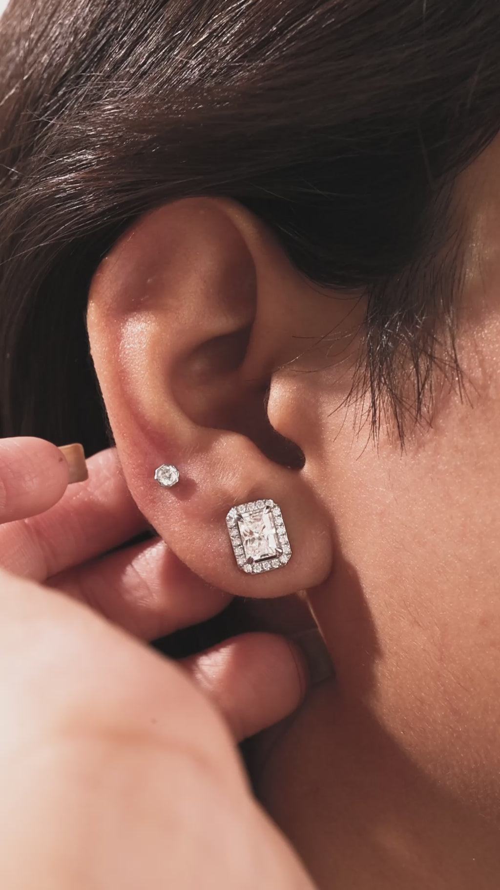 18k yellow gold Radiant Diamond Halo Earrings made with a radiant-cut solitaire diamonds set in a four prong setting