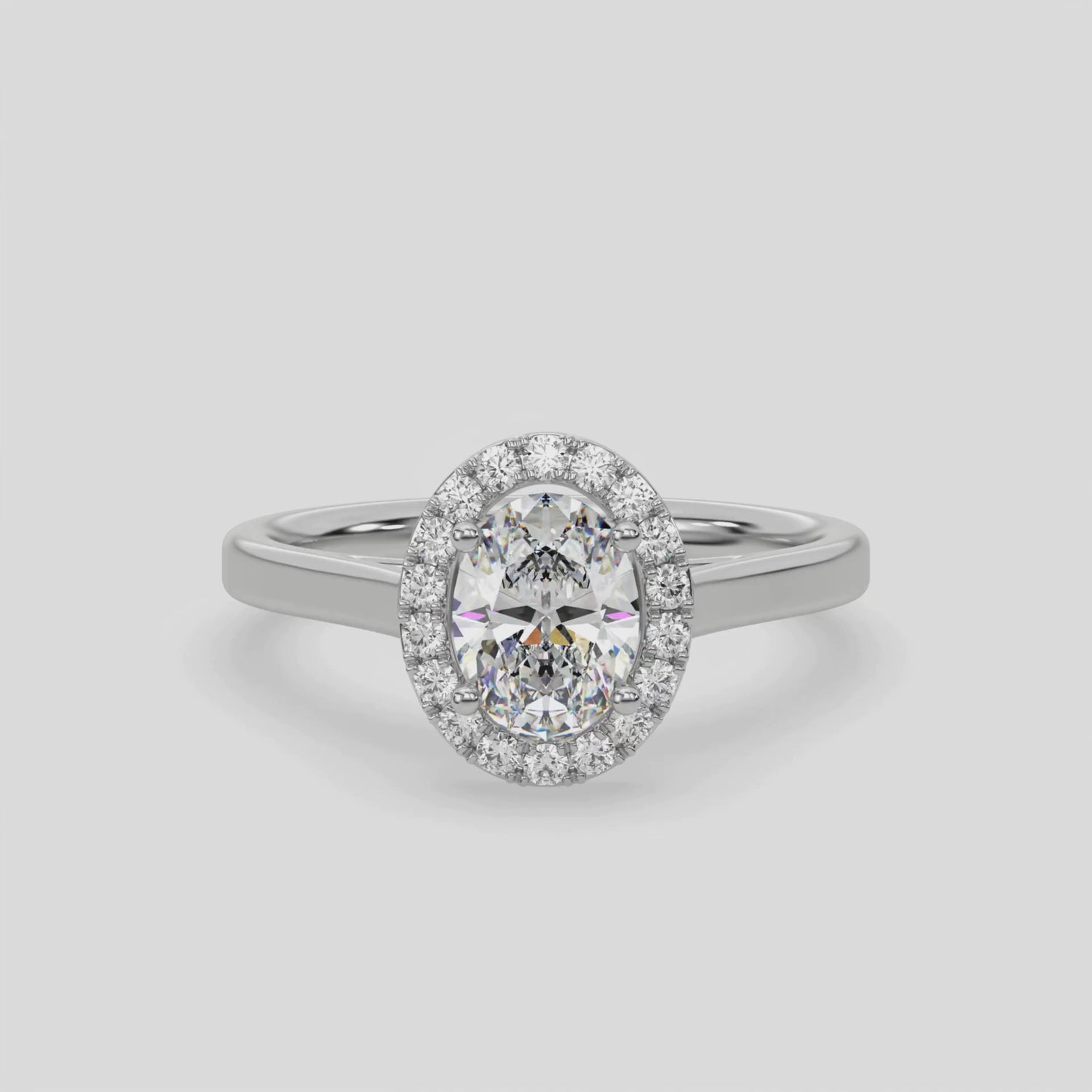 This video features a white gold ring is made with an oval solitaire diamond set in a four-prong setting