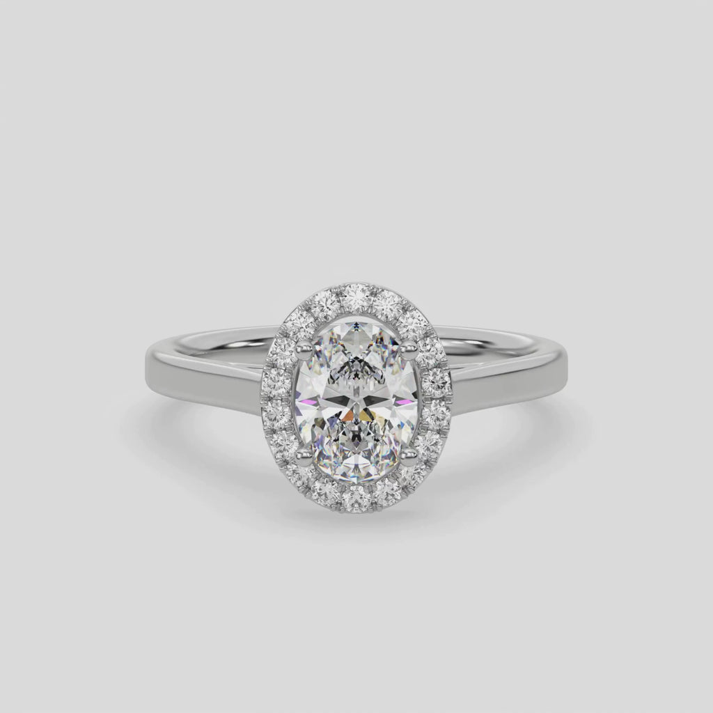 This video features a white gold ring is made with an oval solitaire diamond set in a four-prong setting