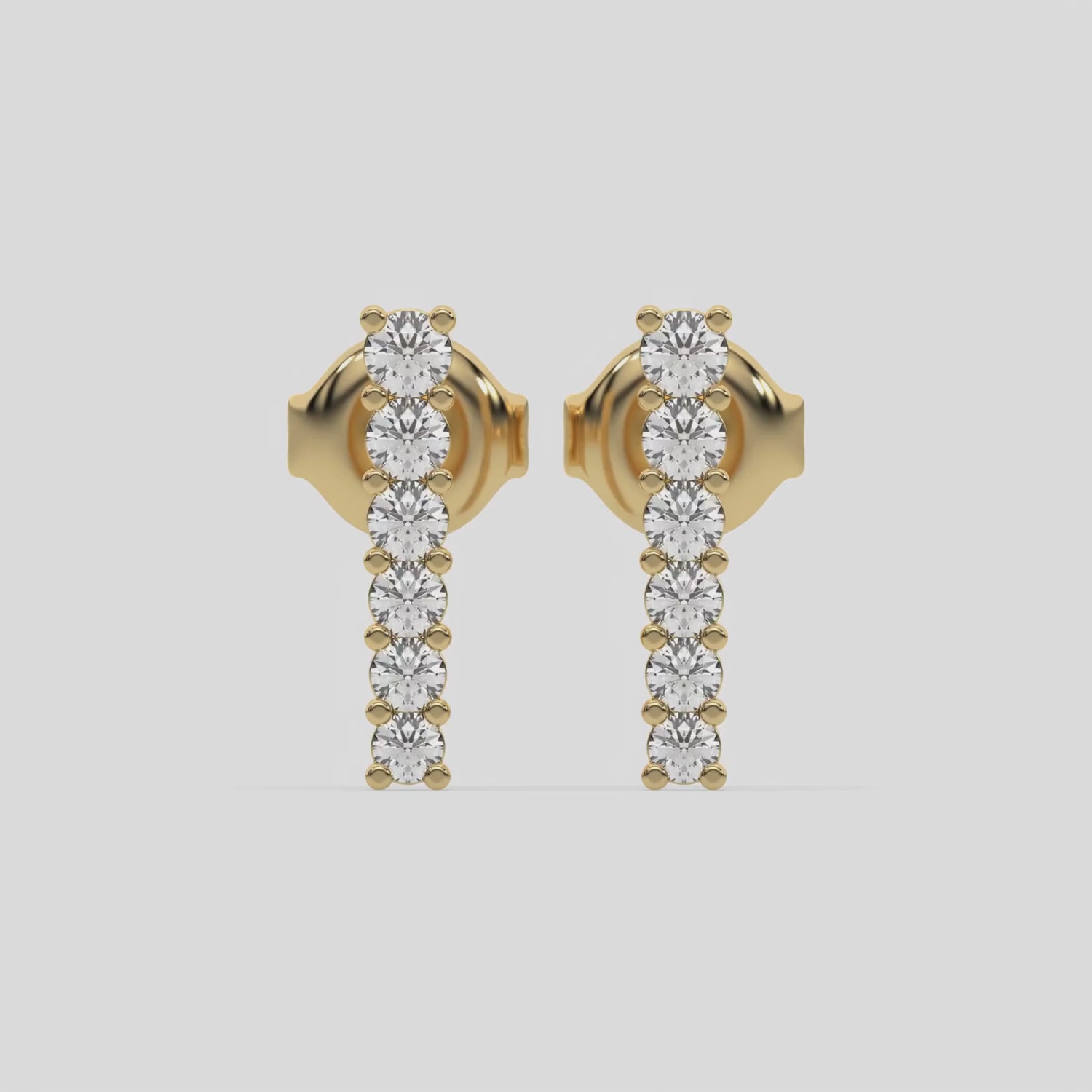 This video features a yellow gold Bar Diamond Earrings made with small round brilliant-cut diamonds set horizontally in shared prong setting