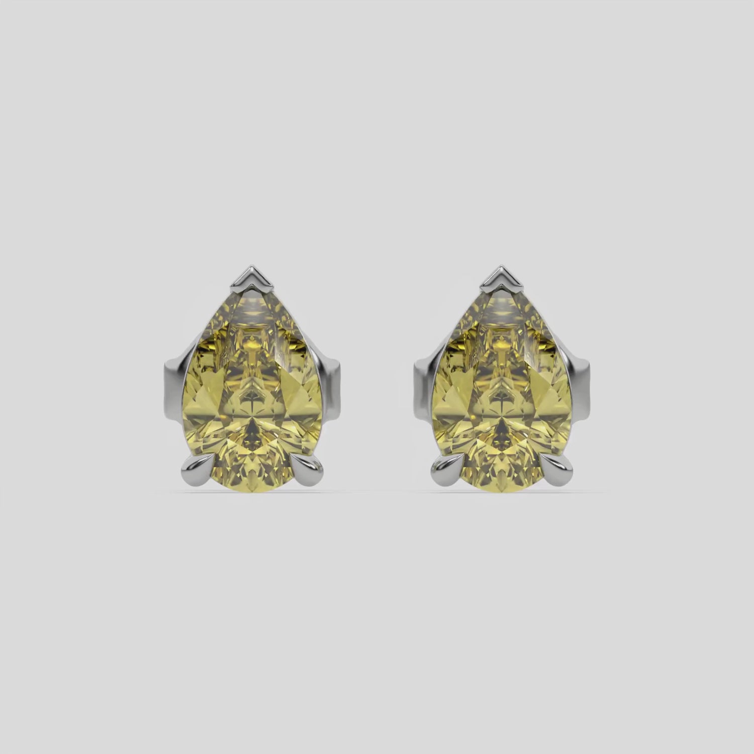 This video features a white gold Classic Pear Diamond Earrings made with a fancy yellow pear-cut diamonds set in a four prong setting