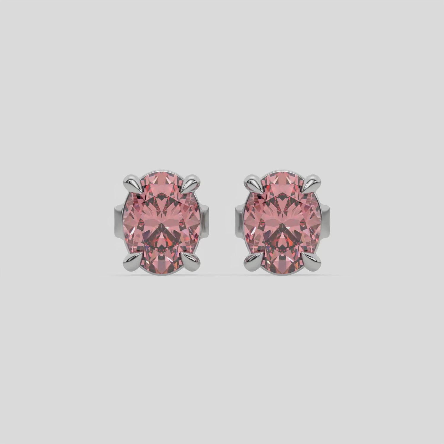 This video features a white gold Classic Oval Diamond Earrings made with an fancy pink oval-cut diamonds set in a four prong setting