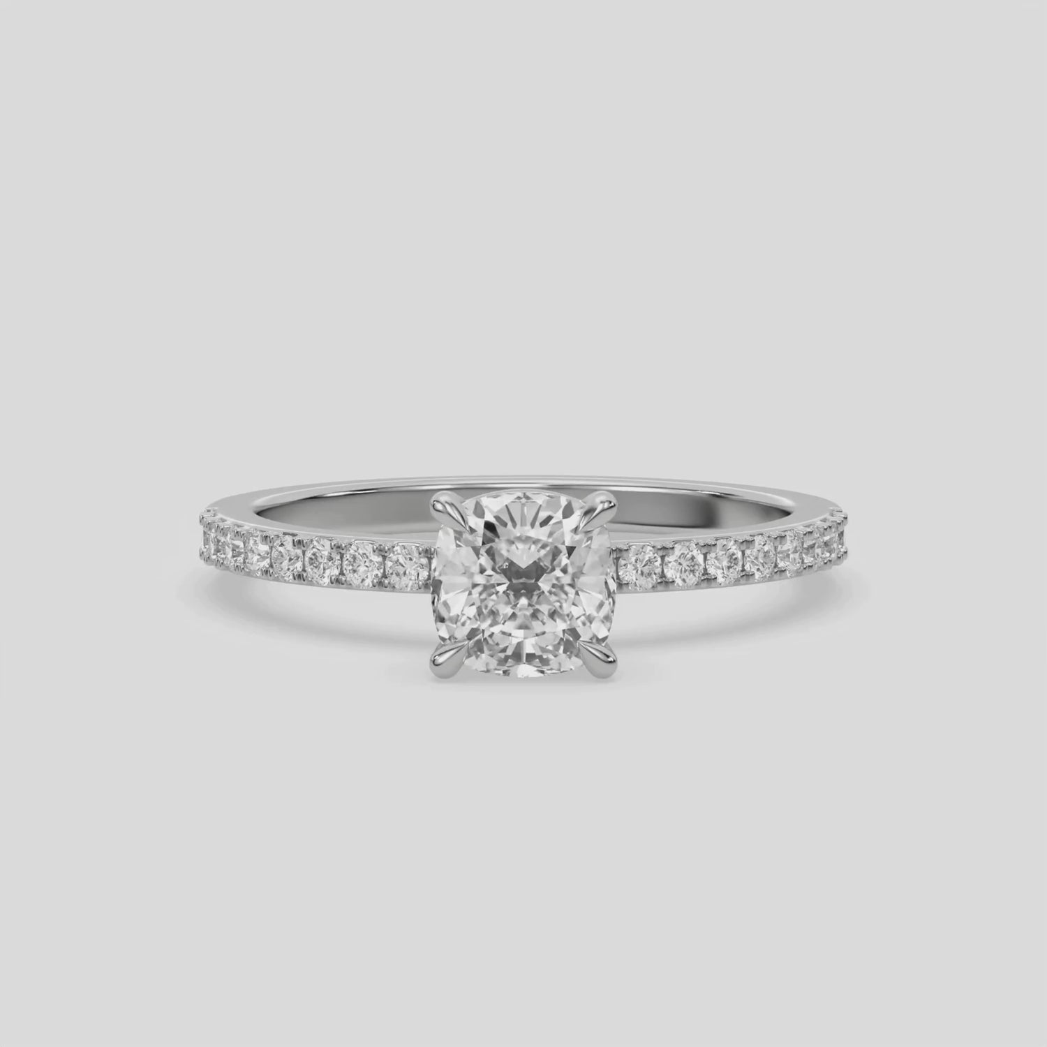 This ring is made with a cushion diamond set in four-prong setting, and is complemented by a round pave diamonds band.