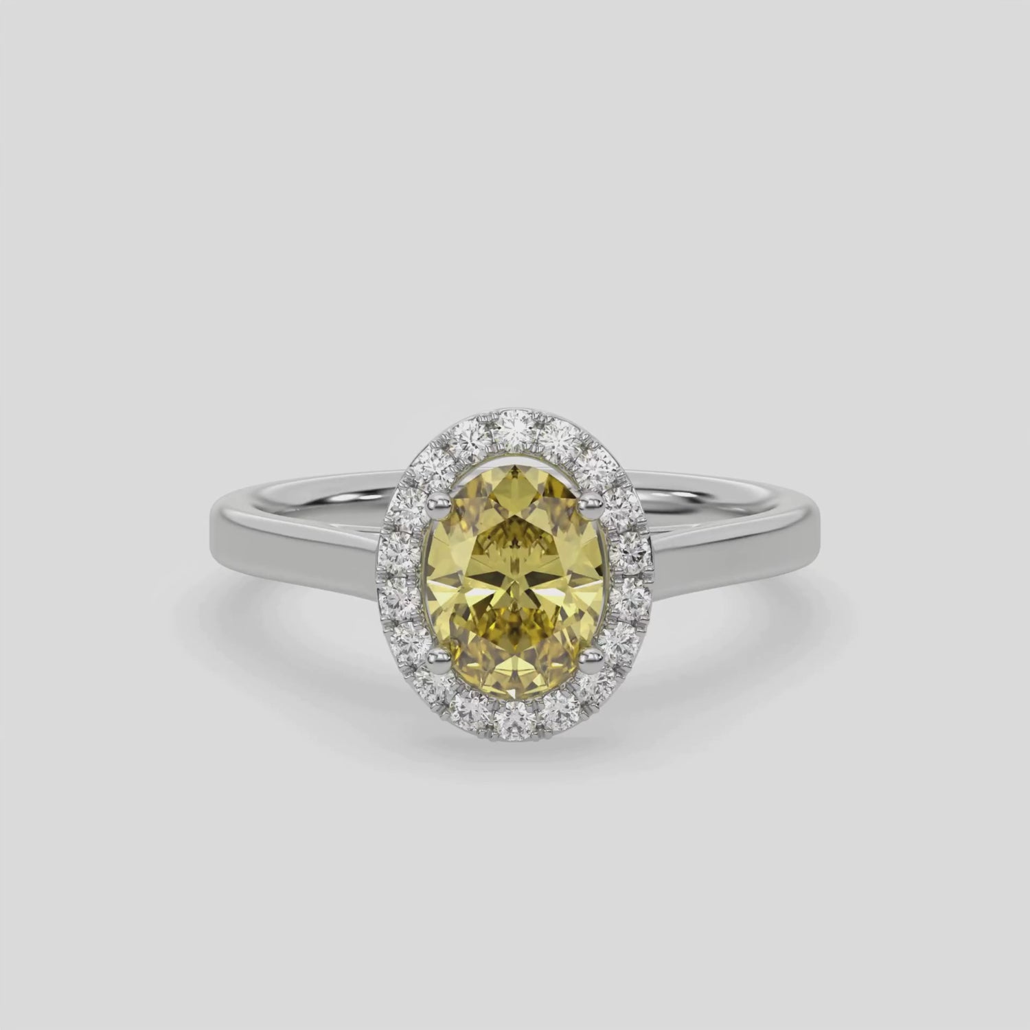 This video features a white gold ring is made with an fancy Yellow oval solitaire diamond set in a four-prong setting