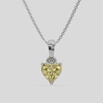 This white gold Fancy Yellow Heart Solitaire Diamond Necklace made with a fancy yellow heart cut diamond in a four prong setting with adjustable chain