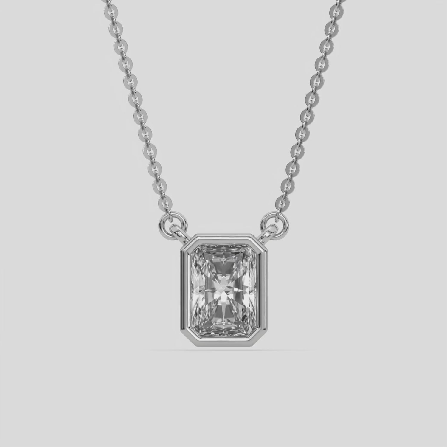 This white gold Radiant Solitaire Diamond Necklace made with a radiant cut diamond in bezel setting with adjustable chain 