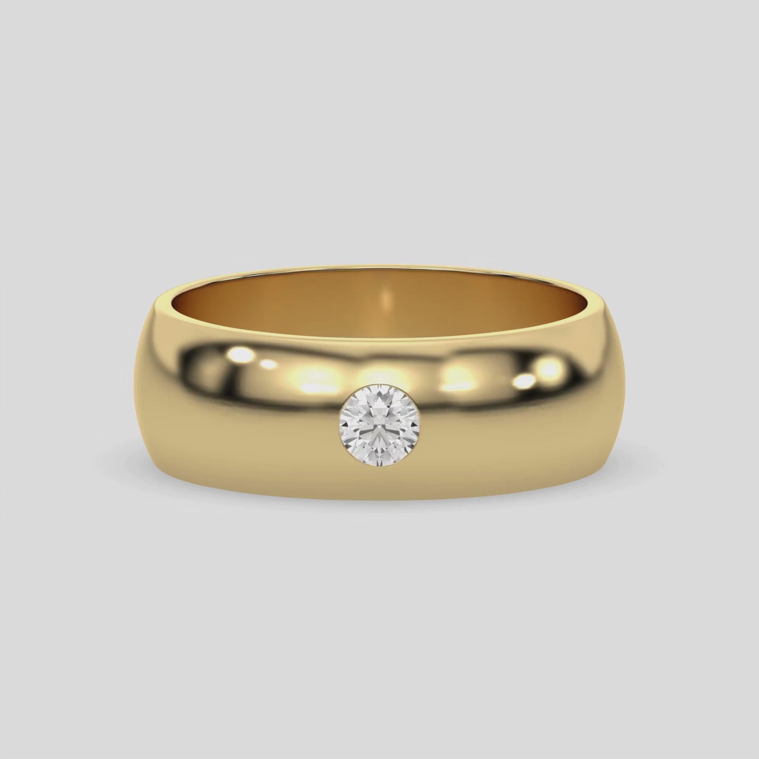 This video features a yellow gold classic flush-set diamond wedding ring, featuring a single round brilliant-cut diamond delicately set in a flush setting