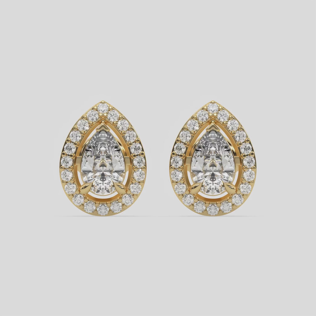 This video features a yellow gold Classic Pear Diamond Halo Earrings made with a pear-cut solitaire diamonds set in a four prong setting