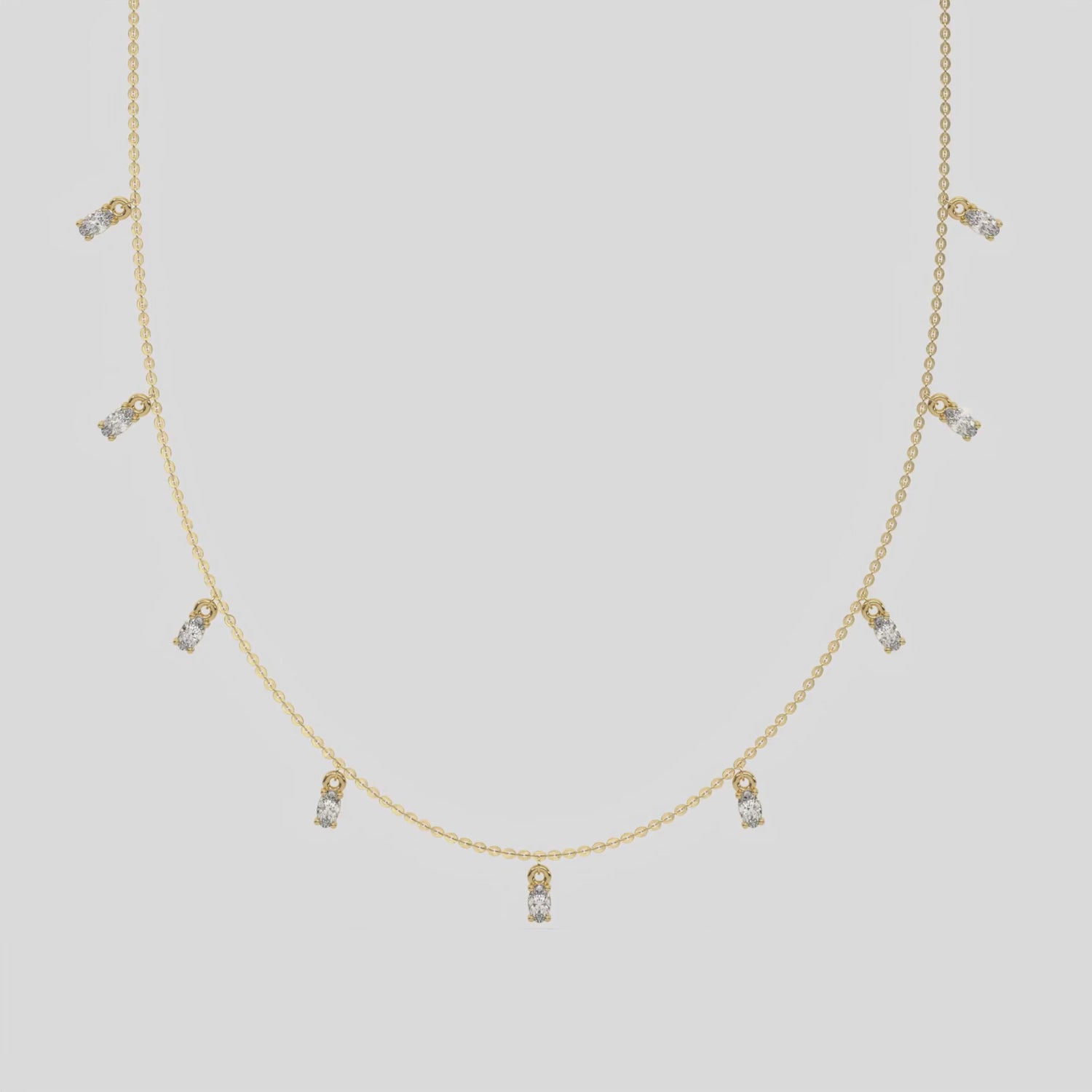 Oval Dangling Diamond Necklace made with nine oval cut diamonds each set in a prong setting, distributed evenly along the chain